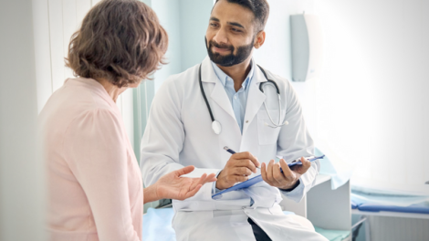 Indian male doctor physician consulting senior pat.