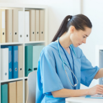 Female Medic Reading Documents in Clinic.